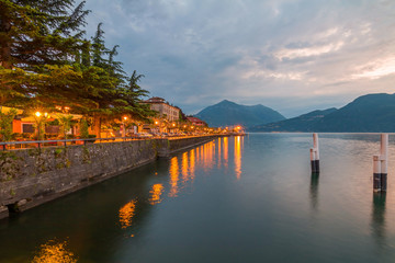 Obraz premium holidays in Italy - a view of a city Bellano, with the most beautiful lake in Italy - Lago di Como in background. Area of famous Belano City at sunset