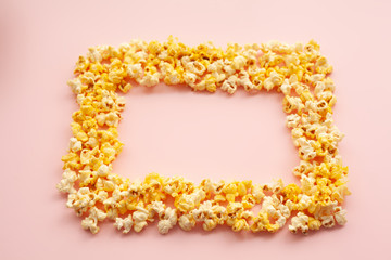 Food. Frozen Popcorn Corn Delicious Yellow Popcorn on Pink Background. Cinema. Copyspace. Place for Text.