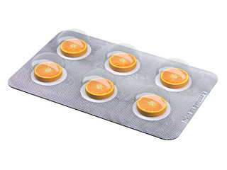 orange slice pills in blister isolated on white background