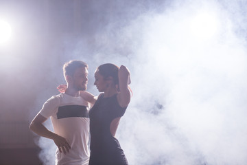 Active happy adults dancing bachata together in dance class