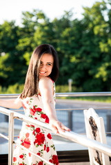 Beautiful brunette girl posing at restaurant terrace .