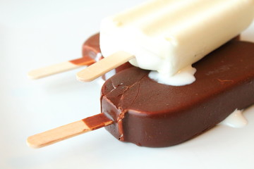 Creamy ice cream on a stick in chocolate glaze and white glaze. Eskimo. Close-up. Background.