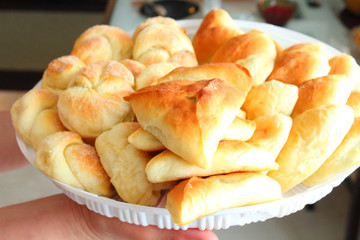 Various pastries on a tray. Buns with sugar. Echpochmak. Pies with eggs and onions.