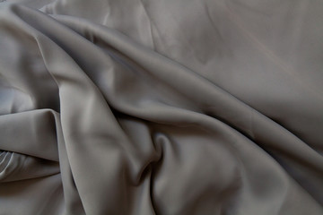 Obraz premium Crumpled grey silk fabric background