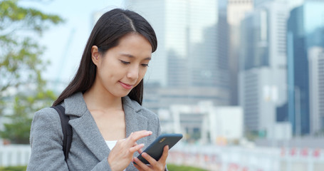 Businesswoman use of smart phone in Hong Kong