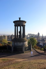 Fototapeta na wymiar Dugald Stewart Monument and Edinburgh's skyline from Calton Hill.