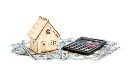 Model of house and calculator on the pile of money. Isolated on white.