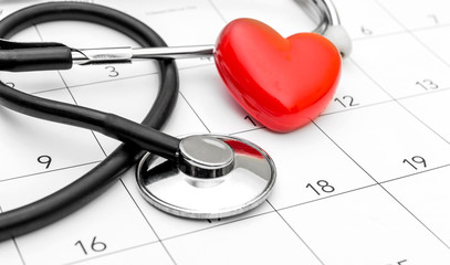 Calendar with stethoscope and red heart. Date for medical examining.