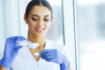 Health. The Doctor Holds Contact Lens in her Hand. Ophthalmologist with Eye Drops. Woman Holds...