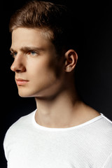 Male in white sport suit on black background