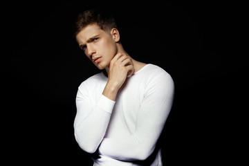 Male in white sport suit on black background