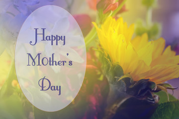 Happy Mothers Day in Oval Frame on soft background of purpe and yellow flowers featuring sunflower