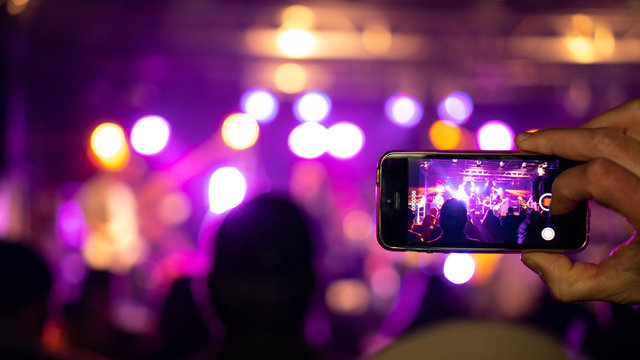 People holding their smart phones and photographing concert. Open air Rock Festival in Germany