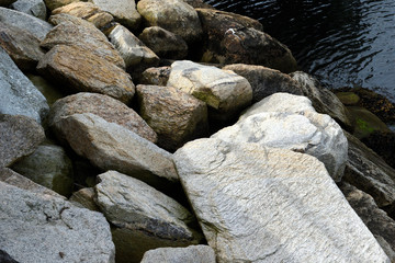 Large rocks on the coast of a bay on a calm morning