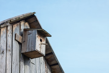 Wooden birdhouse on a  wooden barn wall 3