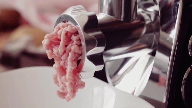 Meat grinder in action - fatty pork minced, close-up, no people