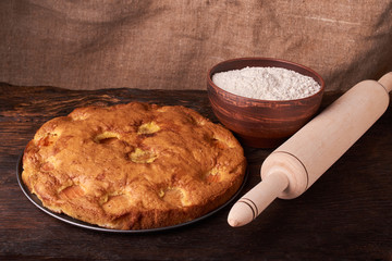 apricot pie and a bowl with flour and other ingredients and tools table