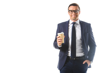 smiling businessman in eyeglasses holding paper cup of coffee isolated on white background