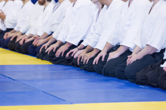 People in kimono and hakama sitting in a line on tatami