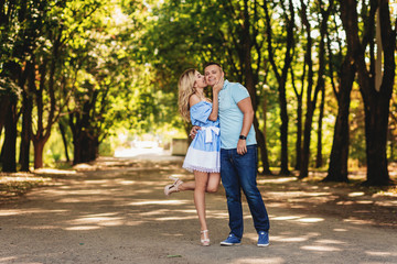Fototapeta premium couple of lovers on a walk along the park avenue. Summer time