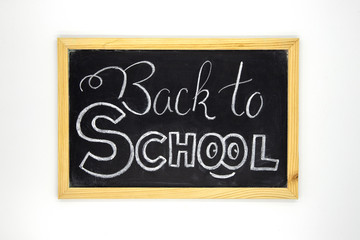 Obraz premium Back to school chalk lettering on blackboard. White chalk Back to school inscription on chalkboard