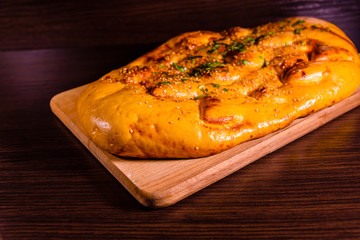 Pita bread with garlic on a wooden cutting board
