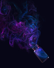 Conceptual photo of the Universe birth, using a translucent bottle and colorful smoke.