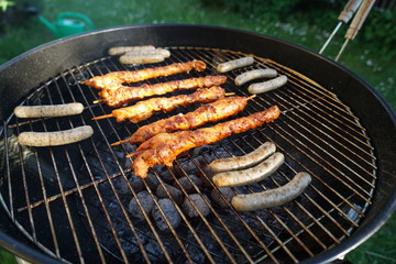 Sausages barbecue with a charcoal barbecue in the garden
