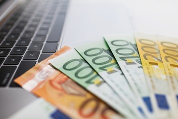Euro banknotes and computer keyboard.