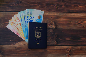 Preparing for a Trip, mobile phone, money, passport on wooden table.