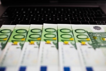 Euro banknotes and computer keyboard.