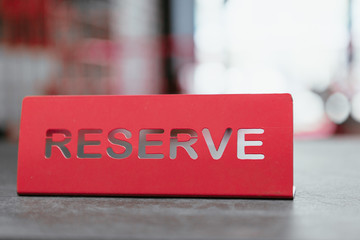 Tablet of red color on a table in a restaurant with a signature reserve