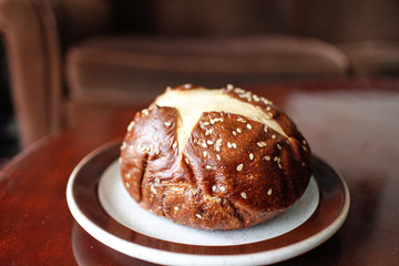 Fototapeta na wymiar baked pretzel Kaiser bun with sesame seeds
