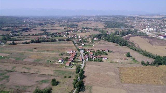 Farm land and small town in Kosovo seen from a distance