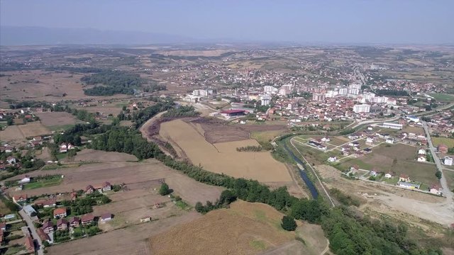 Distant view of farmland and small town in Kosovo