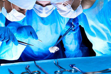 Group of surgeons in masks performing operation. Medicine, surgery and emergency help concepts