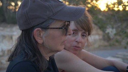 Two middle aged woman talking, close friends, having fun