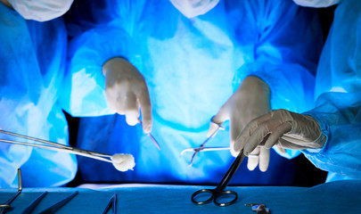 Group of surgeons in masks performing operation. Medicine, surgery and emergency help concepts