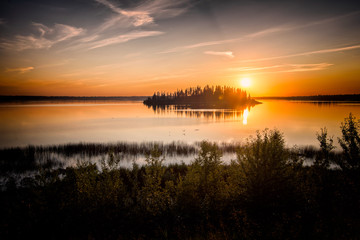 Yellow sunset over river with silhouette