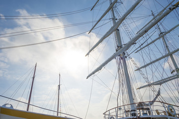 Fototapeta premium Rigging of a tall ship in a port in sunlight in spring
