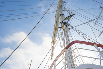 Rigging of a tall ship in a port in sunlight in spring