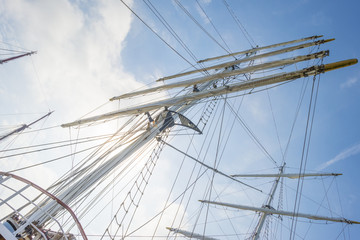 Rigging of a tall ship in a port in sunlight in spring