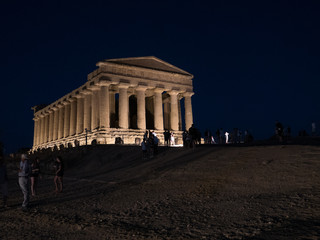 Obraz premium AGRIGENTO, Sicily. August 2017: the Valley of the Temples of Agrigento, an ancient greek temple, perfectly preserved and part of the Unesco World Heritage sites, enlightened at night on the top hill.