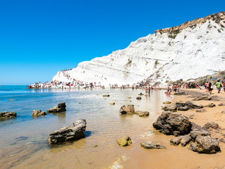“Stairs of the Turks” (italian: Scala dei Turchi), beautiful white rocky cliff made of marl, facing on the Mediterranean Sea, seen from the sandy beach with shallow water - Realmonte, Agrigento Sicily