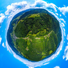 Little planet view of Vosges mountains in Alsace, green earth with blue sky