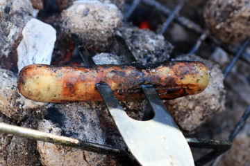 Fototapeta premium Sausages barbecue with a charcoal barbecue in the garden 