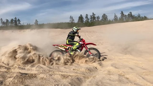 Slow motion enduro mx dirt bike in sand vivid