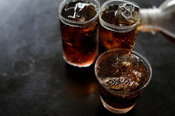 Soft drinks Ice tube in glass On the black table