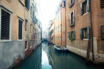 Fototapeta na wymiar Venice Italy Alleyway Canal with Water and Boats