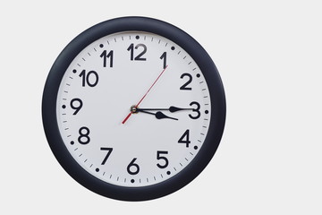 Time concept with black clock at a quarter past three am or pm